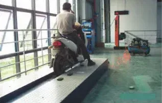 A motorcycle undergoing performance testing on an inspection line.